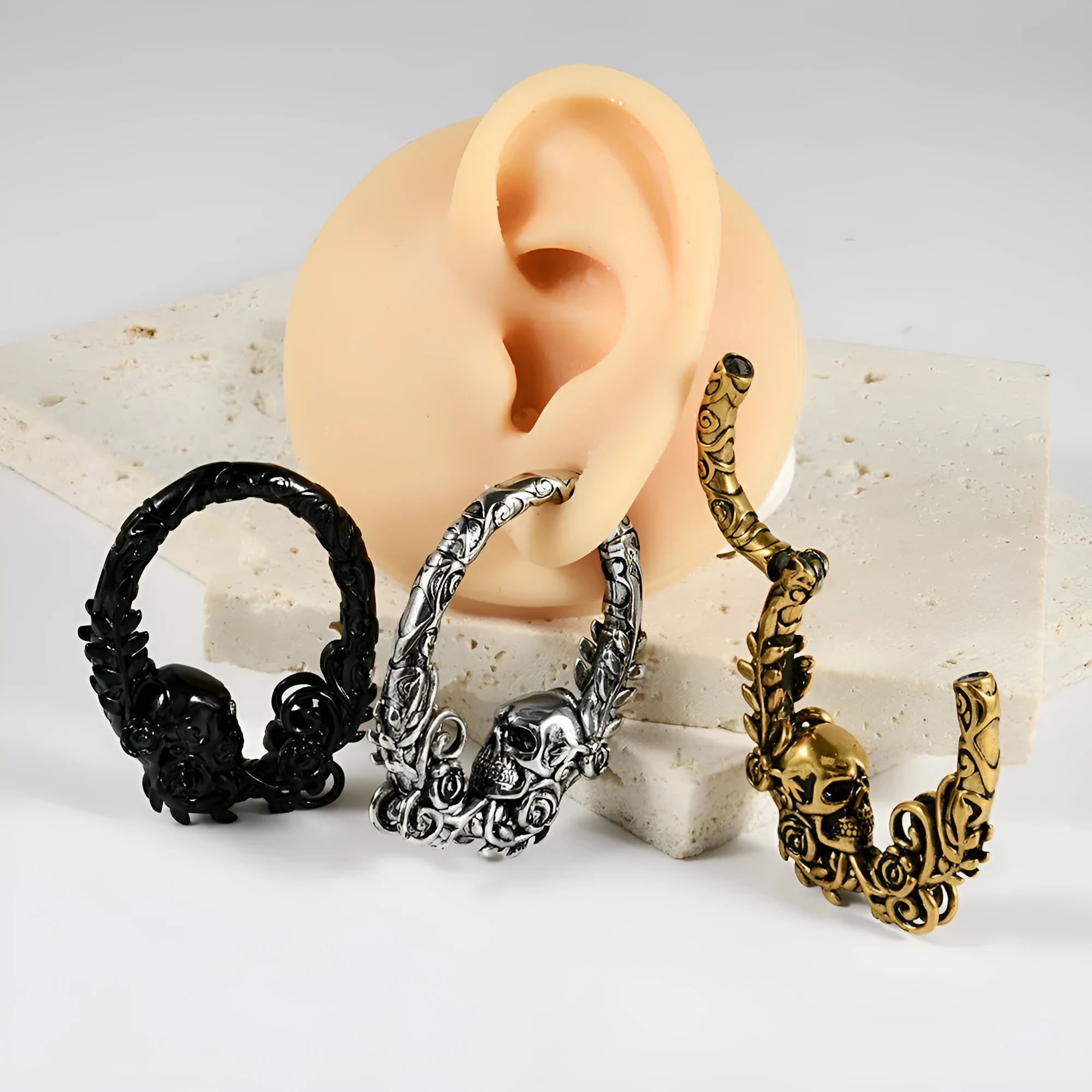 A pair of silver totem pattern stainless steel fashion earrings on a white background.