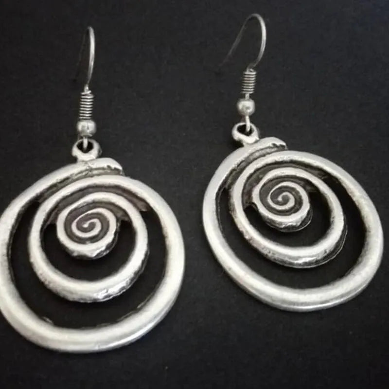 Silver geometric spiral distressed alloy dangle earrings showing retro design.