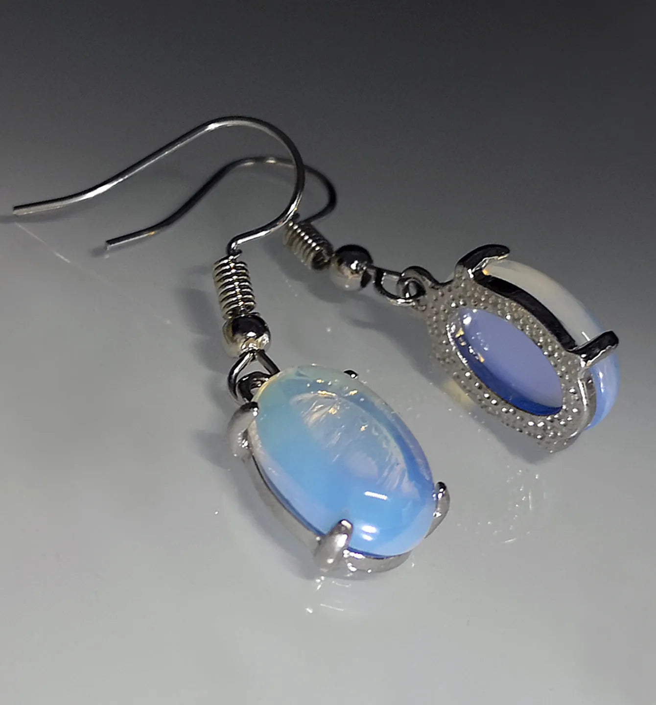 Moonlight white opal earrings with a retro cross pendant in a drop shape