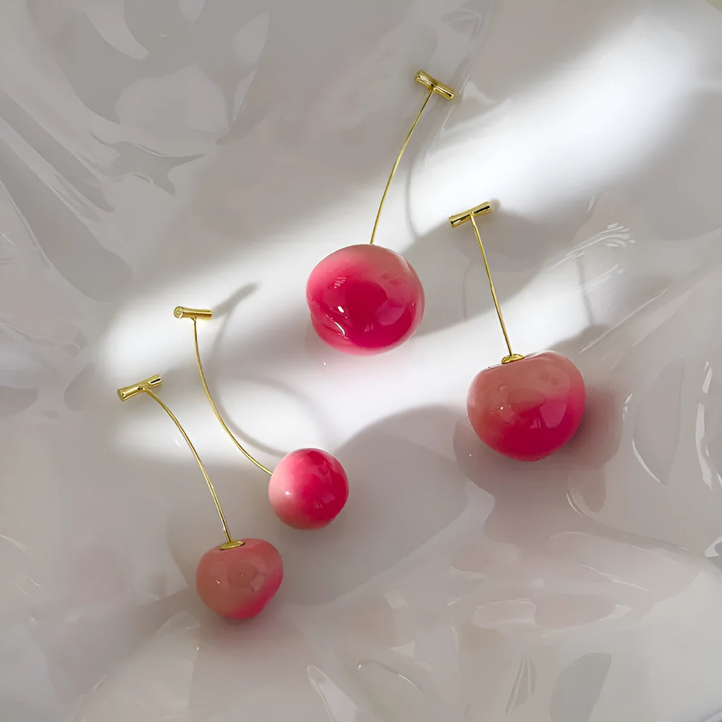 Pair of acrylic peach-shaped earrings on a white background, showing small and large size options.