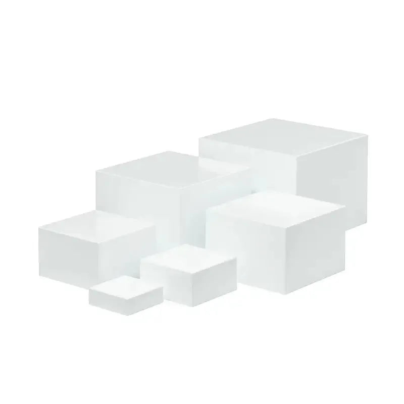 White plastic modular dessert display stand with six interlocking cubes for cake and pastry presentation