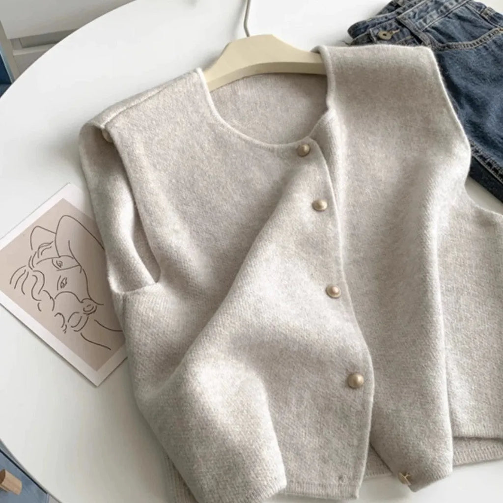 Women's polyester pullover vest with half sleeves in smoky grey, available in medium and large sizes by weight