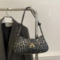 Casual women's handbag in black with sandwich pocket, measuring 27cm wide and made from PU leather