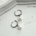 Geometric alloy drop earrings for women with round titanium steel pearl accents.