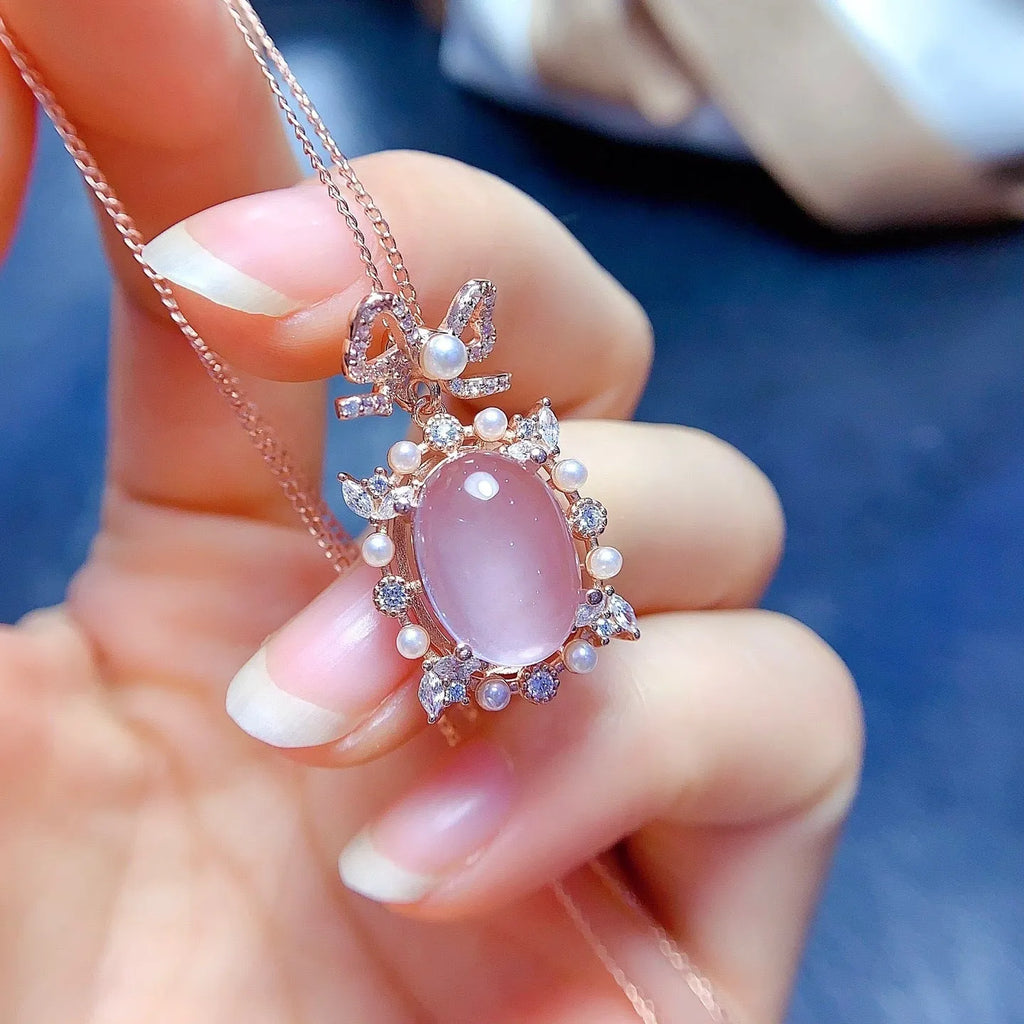 Geometric rose gold plated silver pendant with a pink rose quartz crystal on a necklace chain.