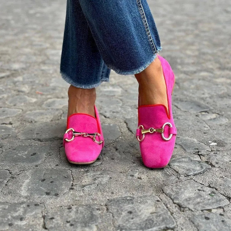 Green women's suede loafers with round toe and metal fastener detail on flat rubber sole