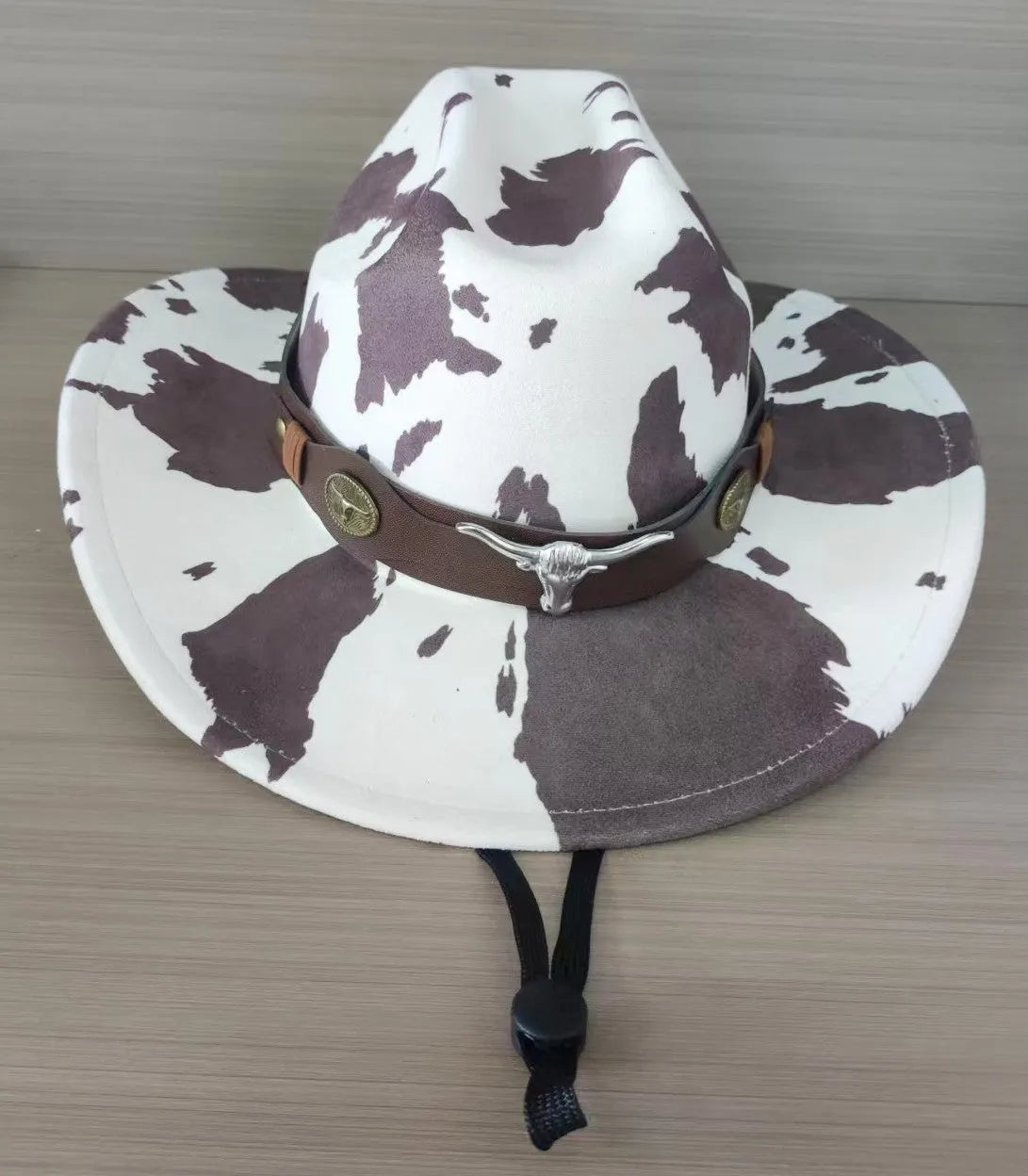 Brown leather velvet western cowboy hat with a curved brim and conical crown on a neutral background.
