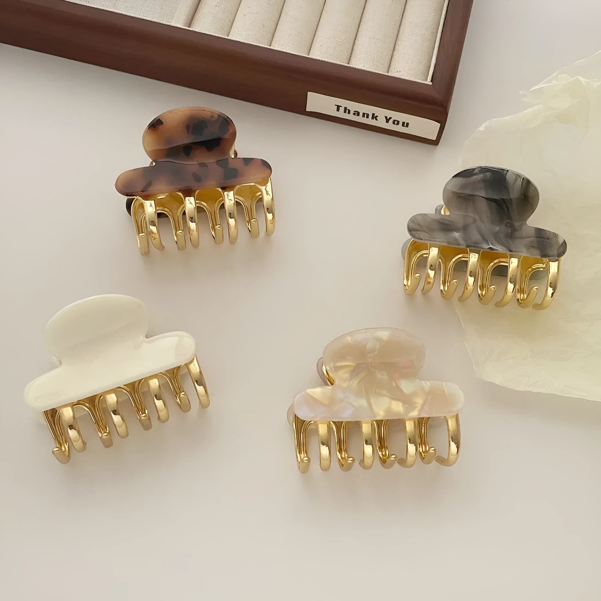 Medium metal grip acetate hair barrettes in four colours: fairy white, leopard print, creamy-white, and ink colour