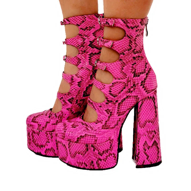 Women's black patent leather platform high heels with a thick heel and buckle-fastened serpentine belt.