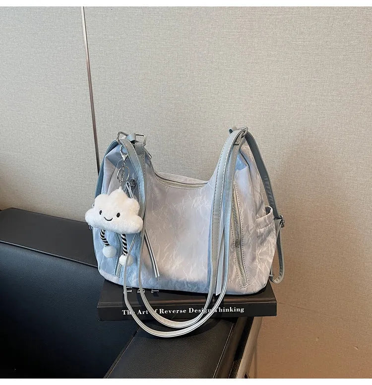 Soft black PU leather women's backpack shown with detachable pendant accessory.