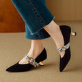 Women's black stiletto high heels with French pointed toe and buckle closure