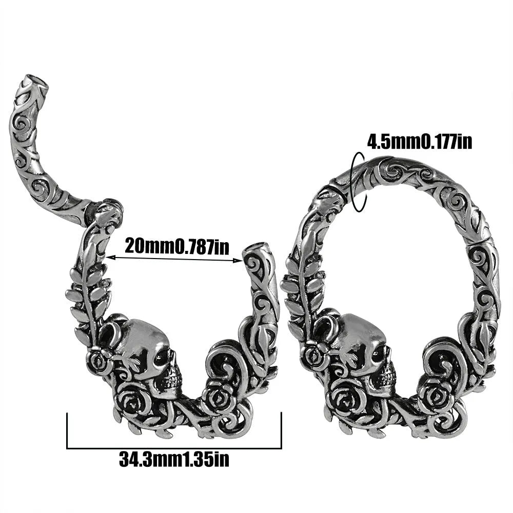 A pair of silver totem pattern stainless steel fashion earrings on a white background.