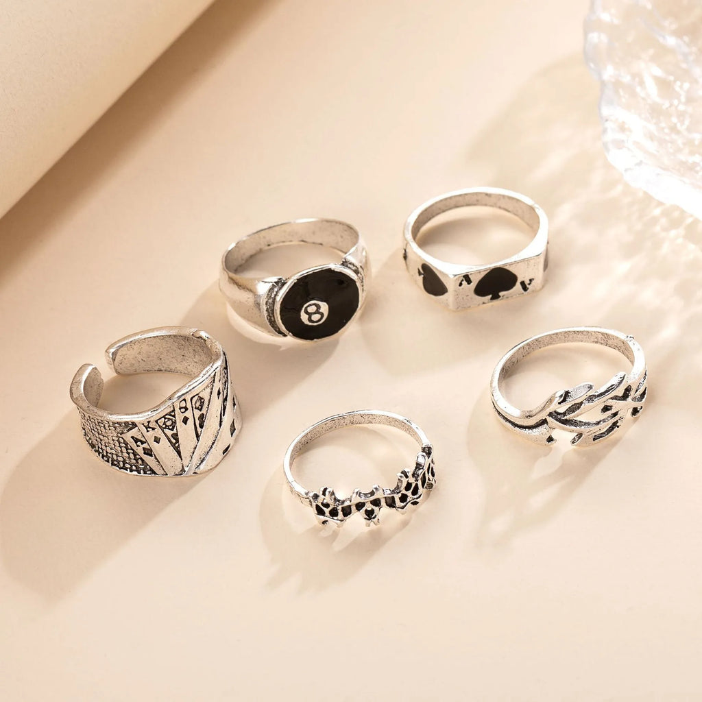 Black alloy poker ring with a detailed retro spade design on a female model's hand.