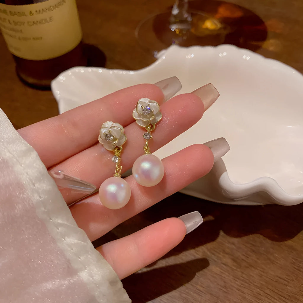 Women's camellia flower stud earrings with pearl accent on alloy base