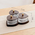 Glass fruit platter with transparent heart-shaped lids covering compartmentalised snack trays in retro design