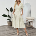 Light green women's shirt dress with lapel collar, waist-tight skirt, and pockets