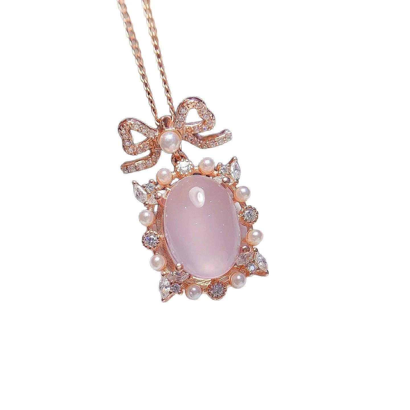 Geometric rose gold plated silver pendant with a pink rose quartz crystal on a necklace chain.