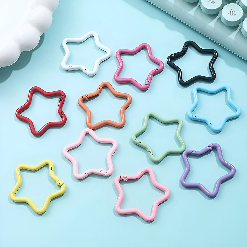 Zinc alloy five-pointed star keychain in light pink colour on a white background.