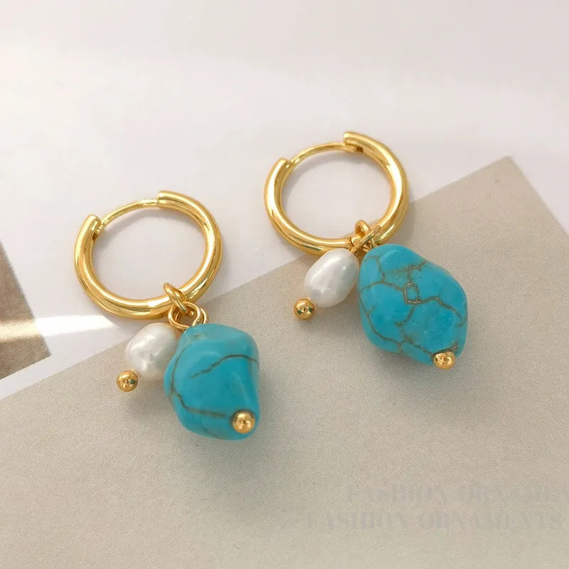 Geometric turquoise and cultured pearl earrings in short stud and long dangle styles on copper settings.