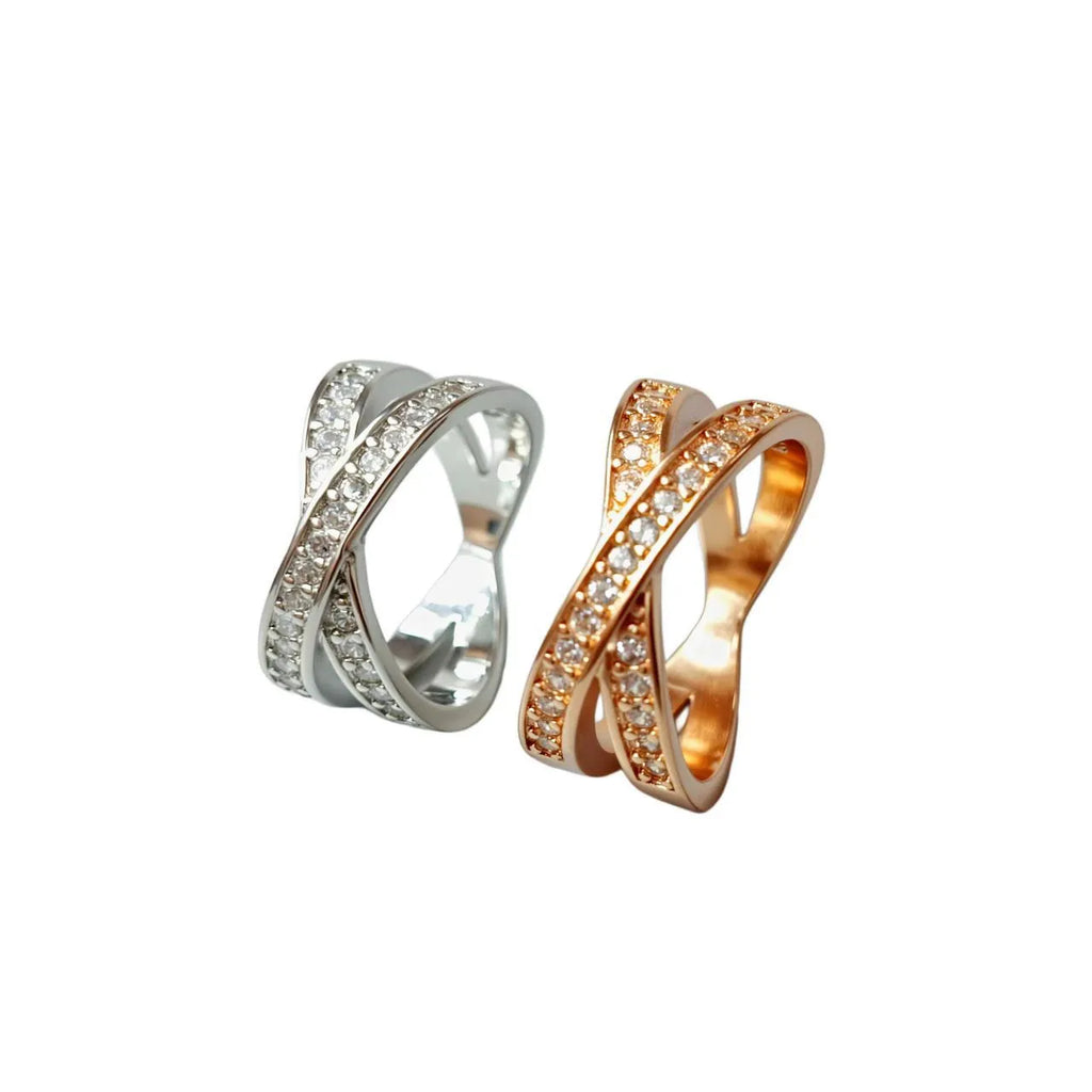 A silver or rose gold plated metal ring with a cross design and micro-inlaid zircon detail.