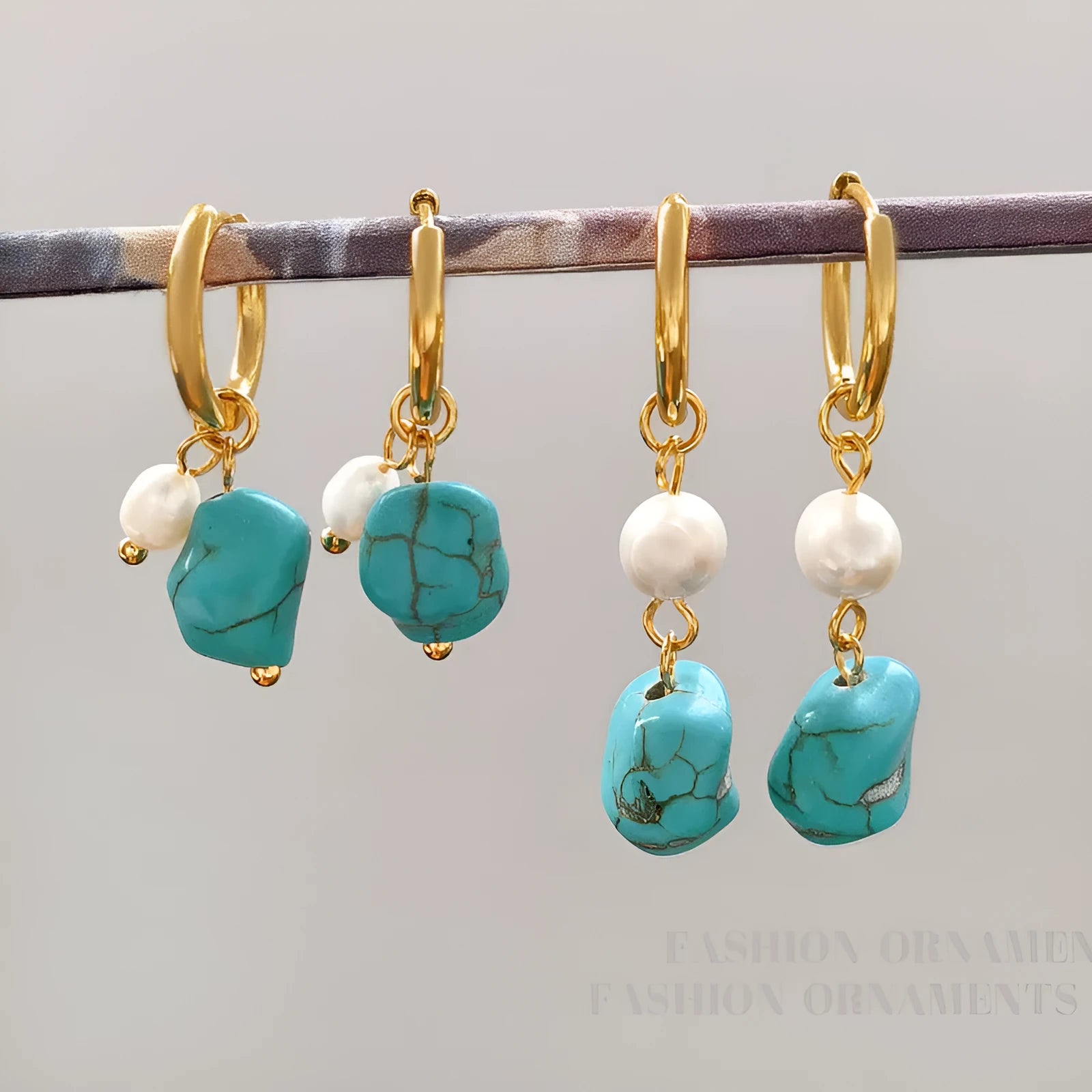 Geometric turquoise and cultured pearl earrings in short stud and long dangle styles on copper settings.