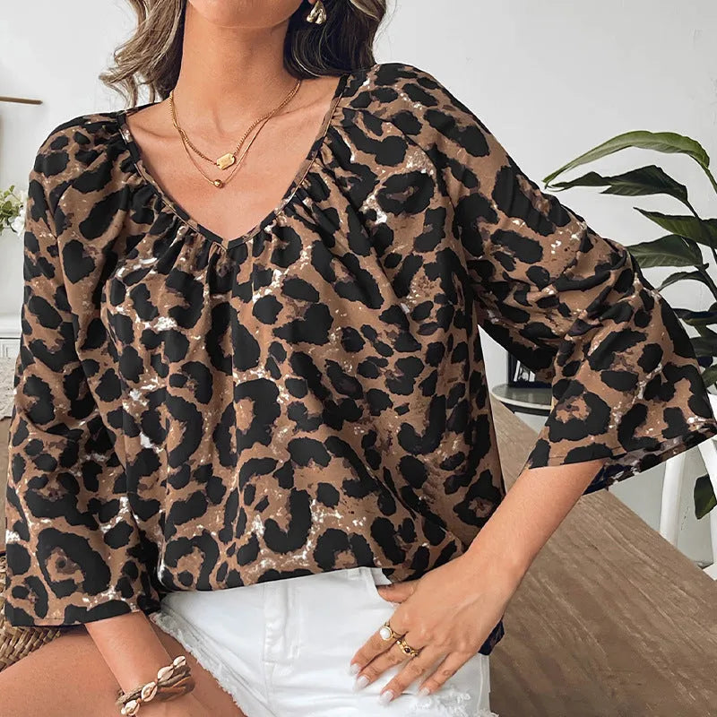 Women's multicolor leopard print V-neck pullover top with half sleeves and pleating detail