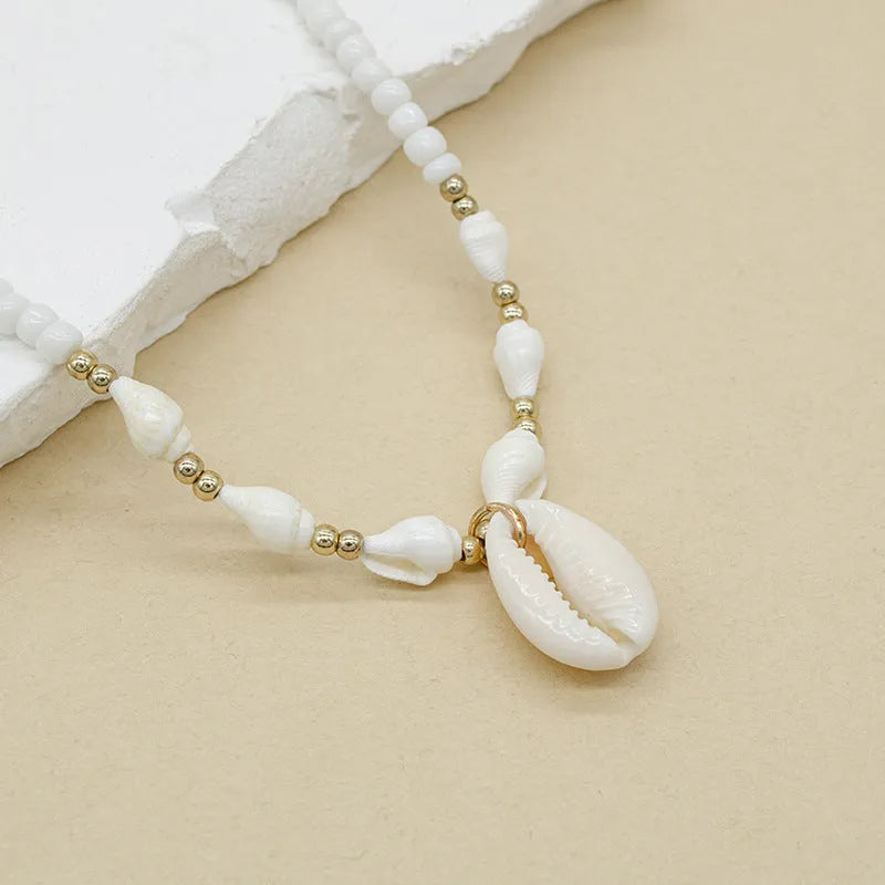 White conch shell necklace with mother of pearl pendant on regular chain, electroplated finish