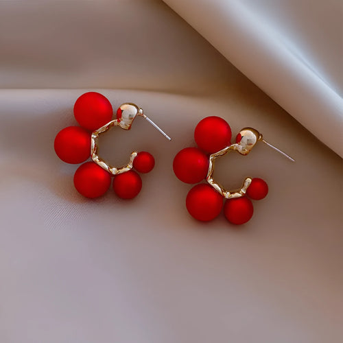 Round alloy bell drop earrings in red colour for pierced ears