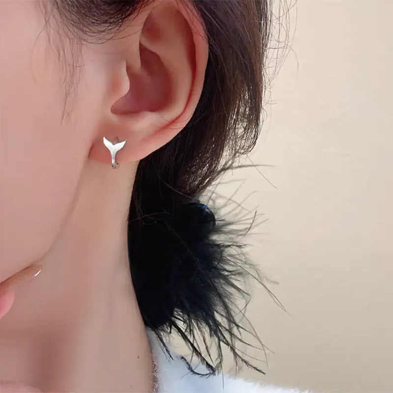 Women's fashion fishtail earrings in copper with electroplated white gold and yellow gold finishes