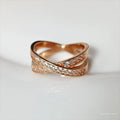 A silver or rose gold plated metal ring with a cross design and micro-inlaid zircon detail.