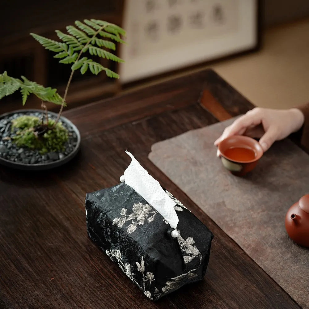 White Chinese brocade tissue box cover with embroidered plum design and optional pearl buckle.