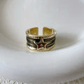Adjustable geometric drop oil copper ring with a distressed finish in multiple colours.