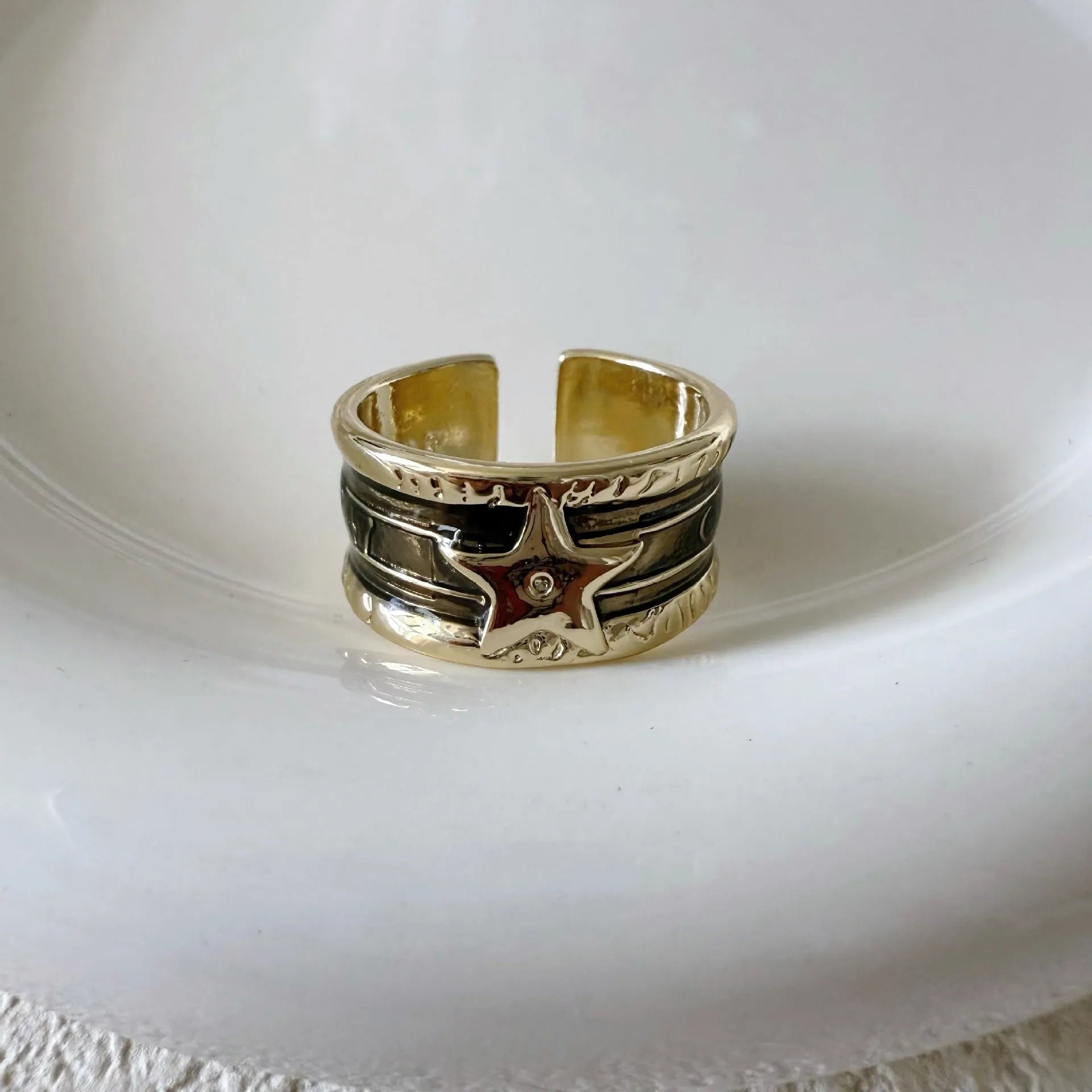Adjustable geometric drop oil copper ring with a distressed finish in multiple colours.