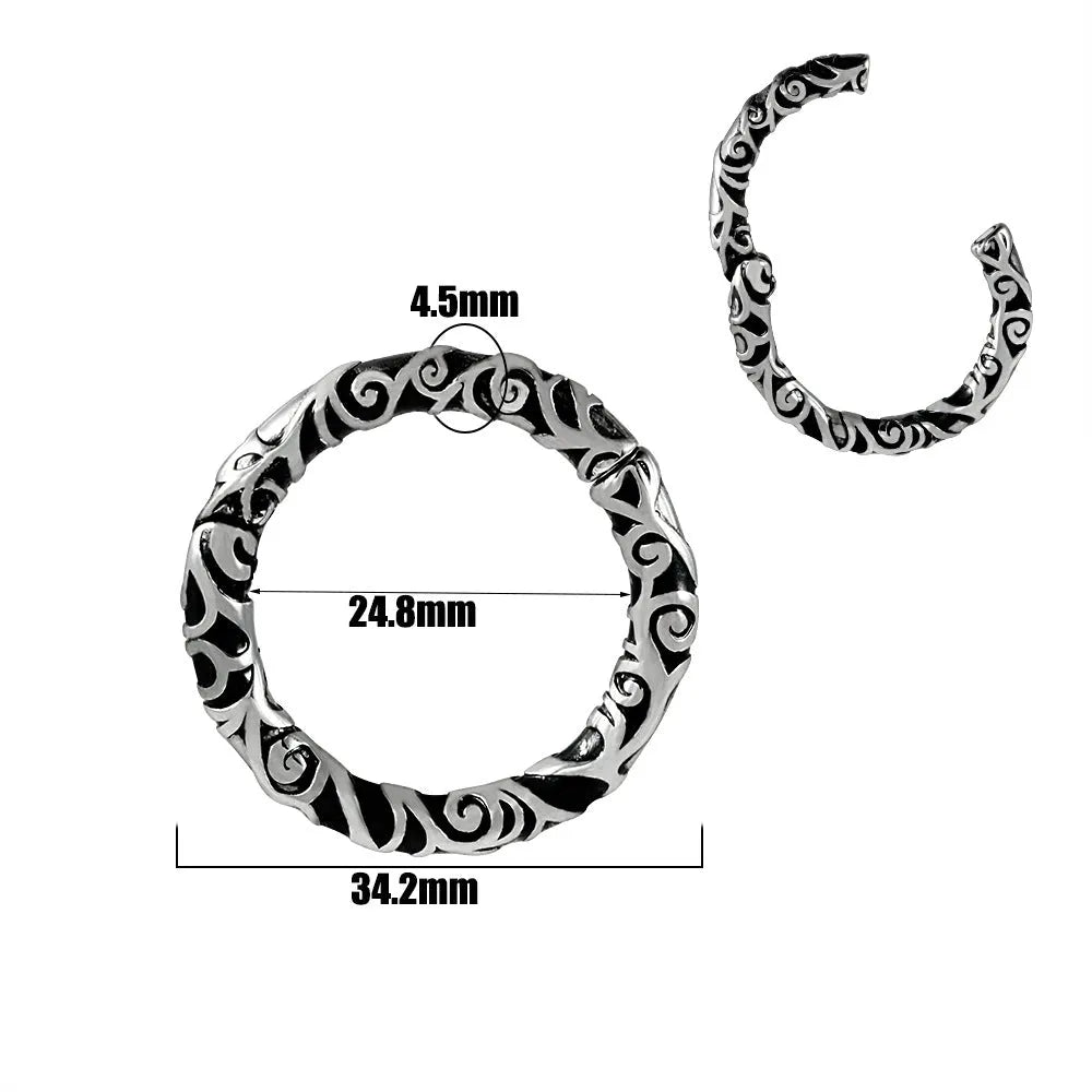 A pair of silver totem pattern stainless steel fashion earrings on a white background.