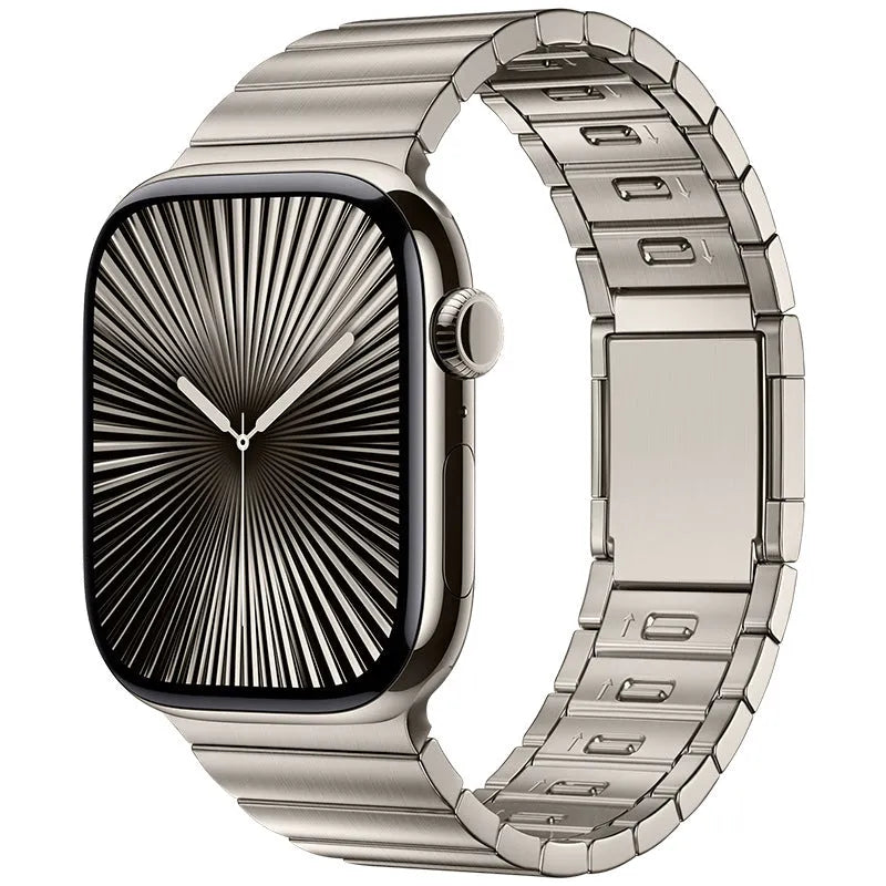 Stainless steel Apple Watch strap with magnetic buckle in multiple colour options on a wrist.