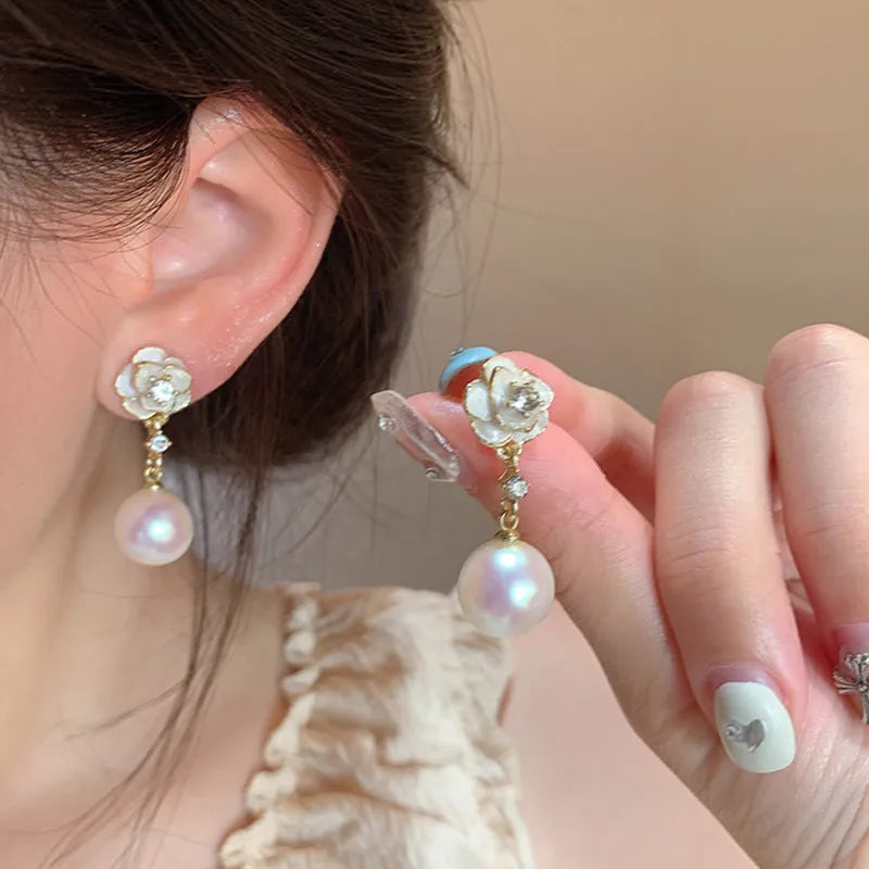 Women's camellia flower stud earrings with pearl accent on alloy base