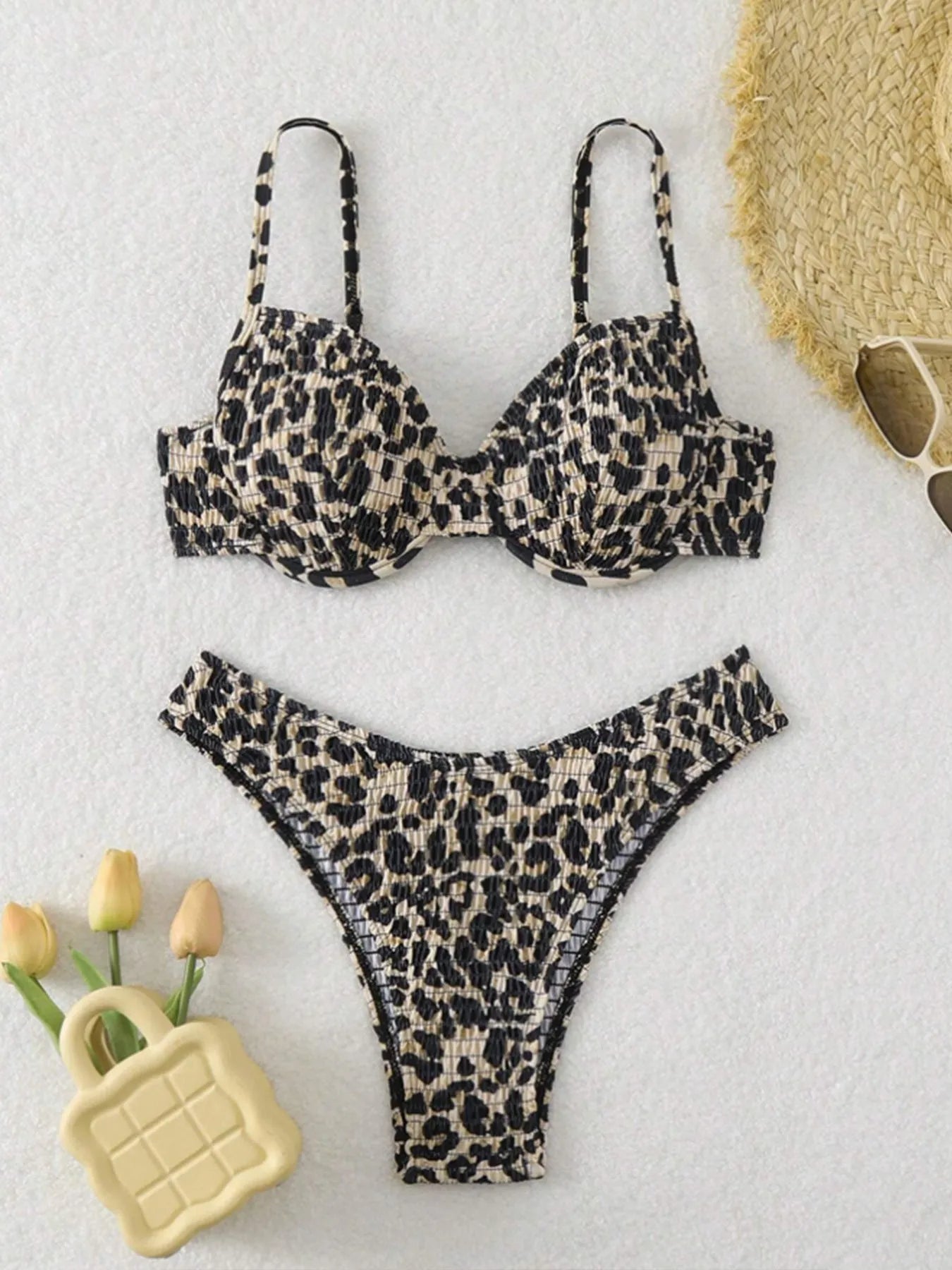 Brown leopard print backless bikini swimsuit for women laid flat.