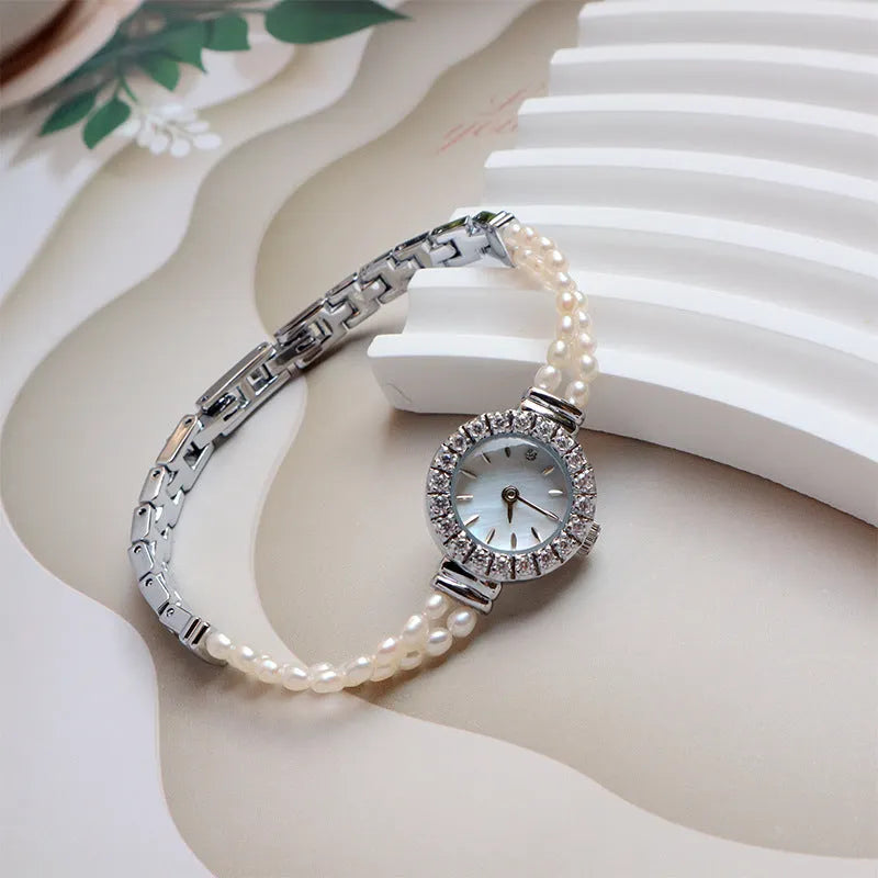 Light gold women's bracelet watch with freshwater pearls and 18mm round dial