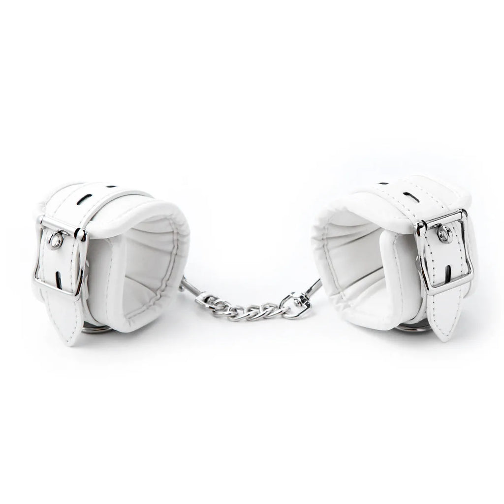 White PU sponge bondage restraint set showing handcuffs, footcuffs and neck cuff accessories