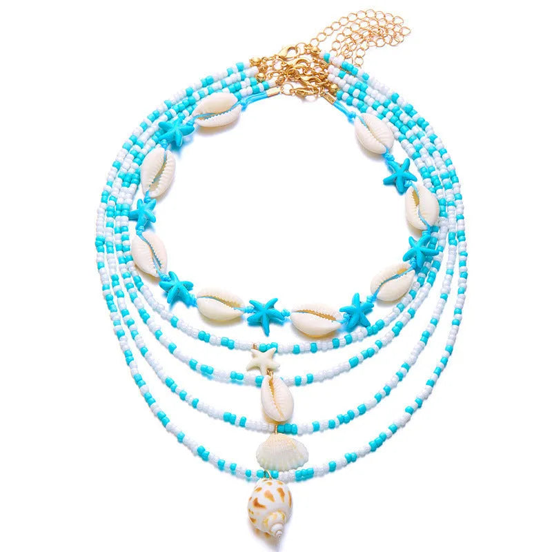 Five-piece women's necklace set with starfish, shell and conch bead pendants on adjustable chains