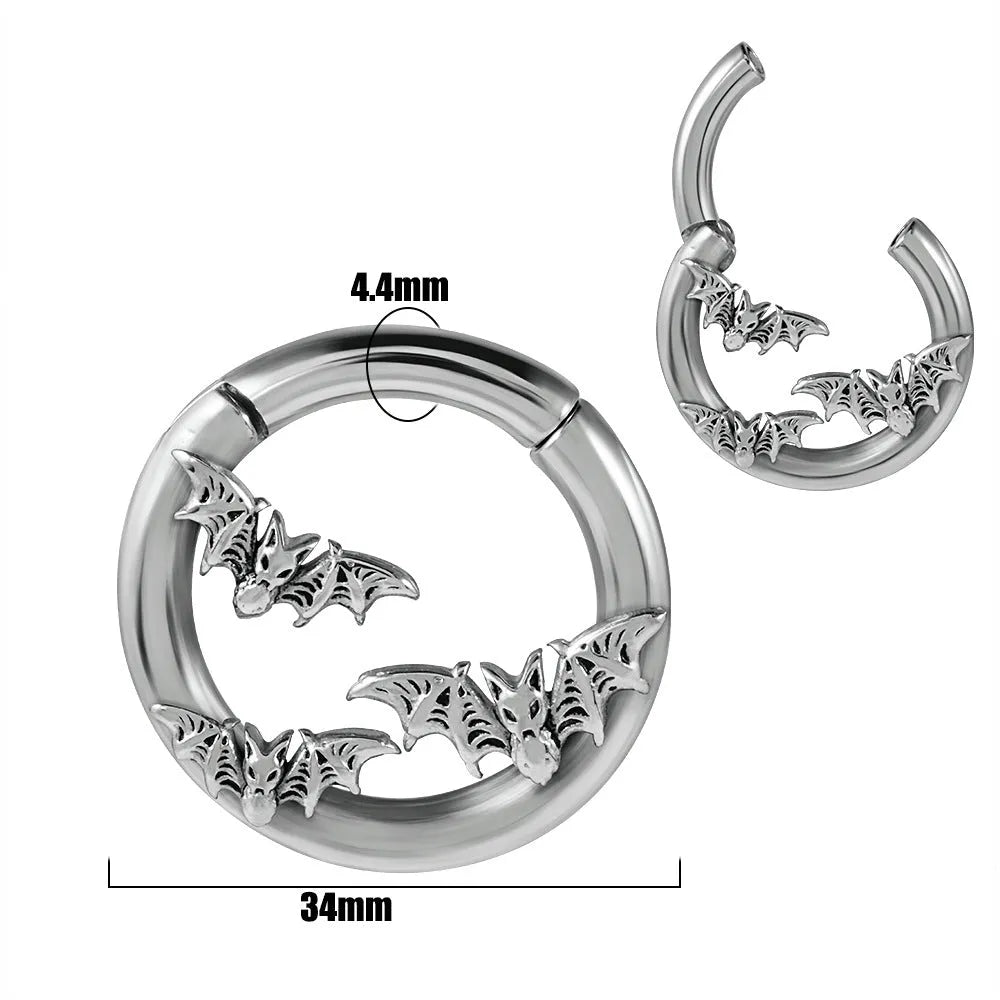 A pair of silver totem pattern stainless steel fashion earrings on a white background.