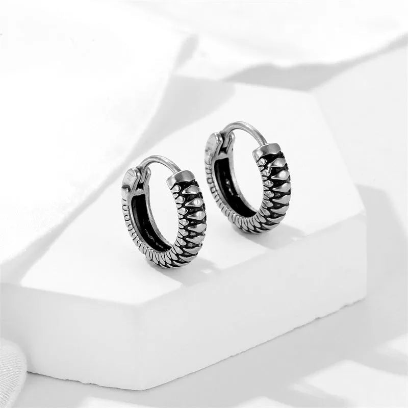 Silver geometric retro twist earrings with stripe detail, made from titanium steel.