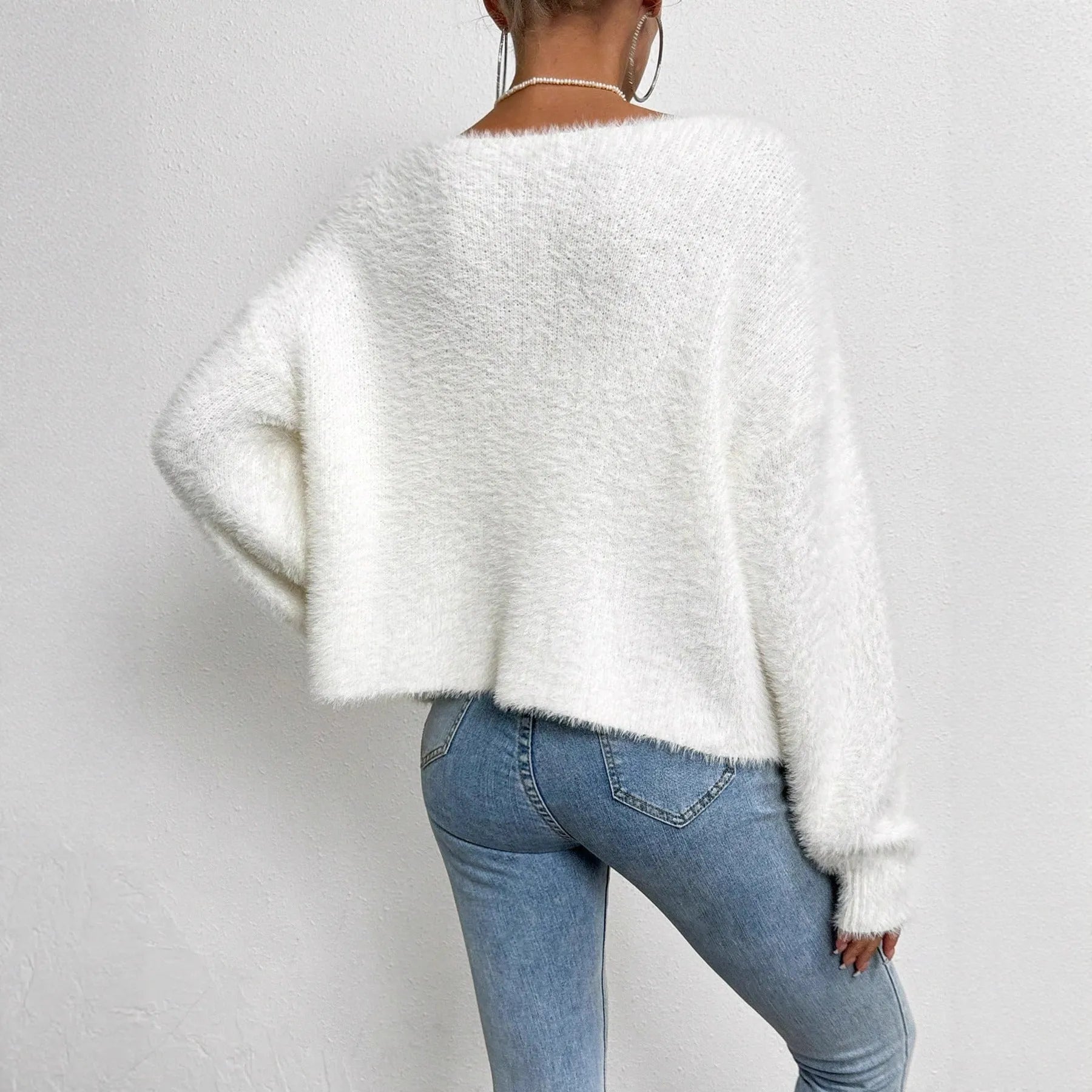 Women's white V-neck cardigan sweater with medium thickness polyester construction