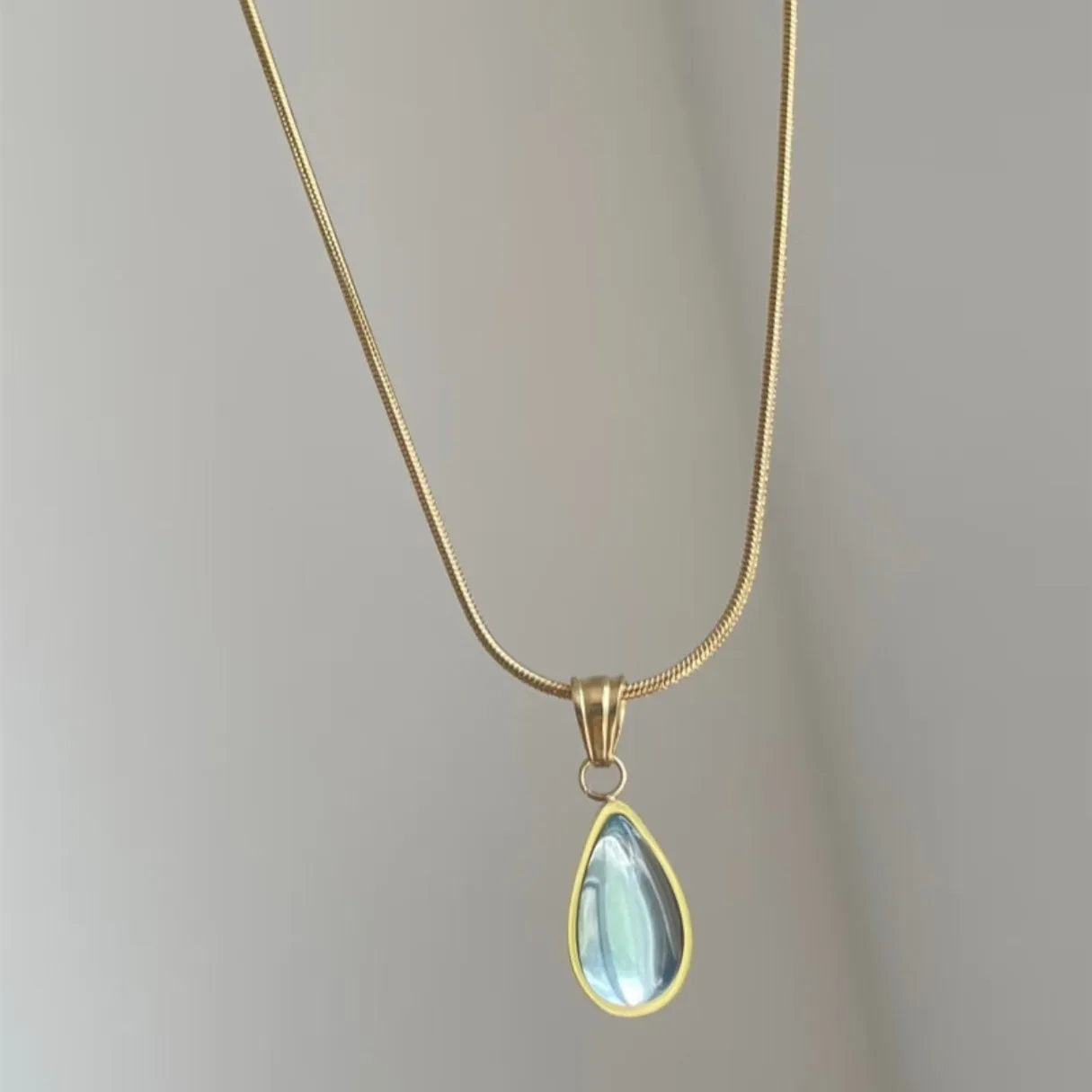 Water drop pendant necklace with gemstone inlay on snake bone chain in blue or green colour