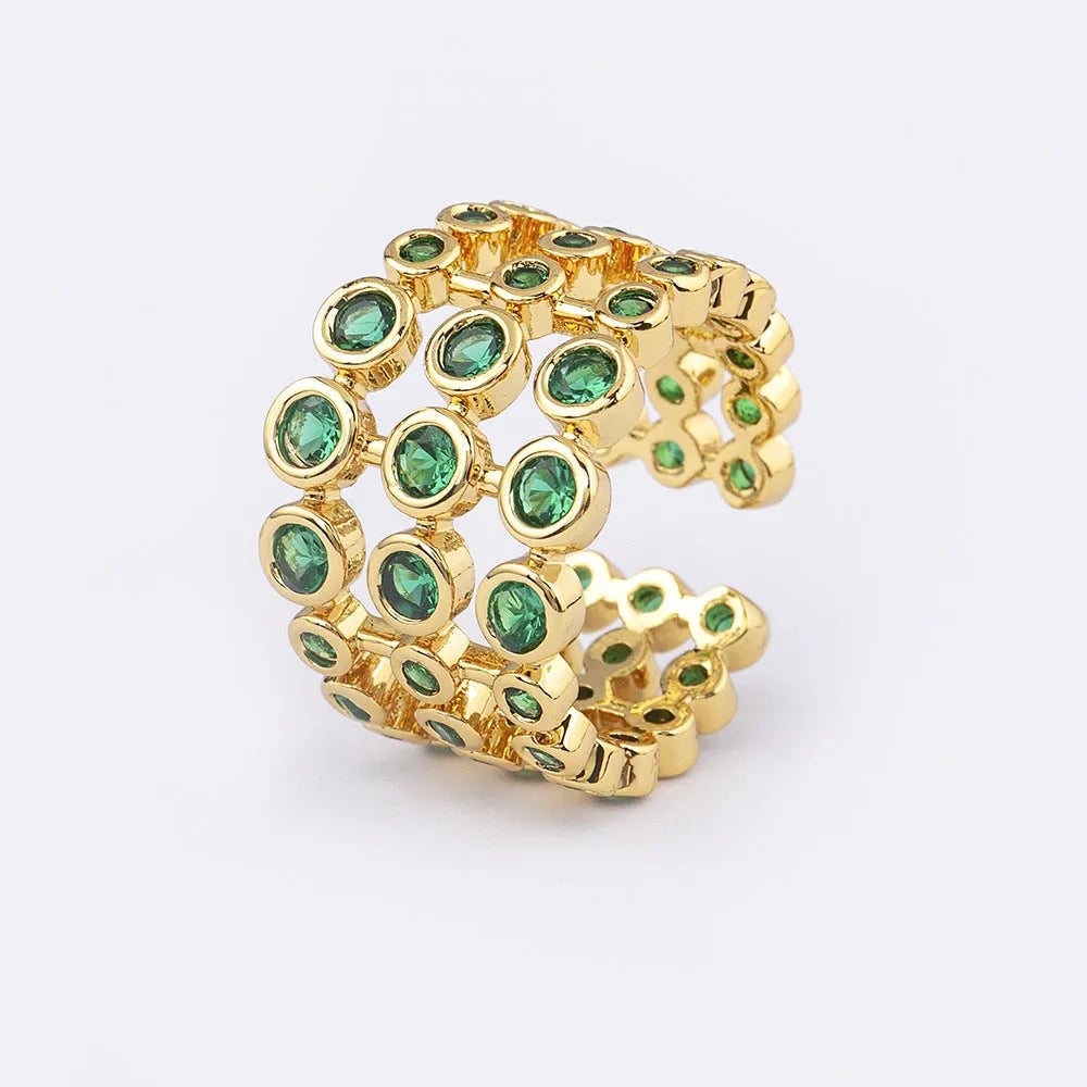 Gold plated copper ring with three green zircon stones in layered arrangement on wide band