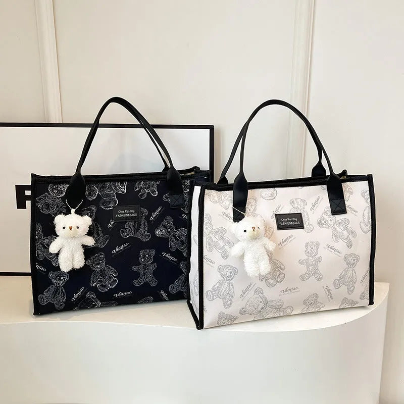 Women's soft canvas tote bag in black, showing large capacity, sandwich pockets, and a rhombus pattern detail.