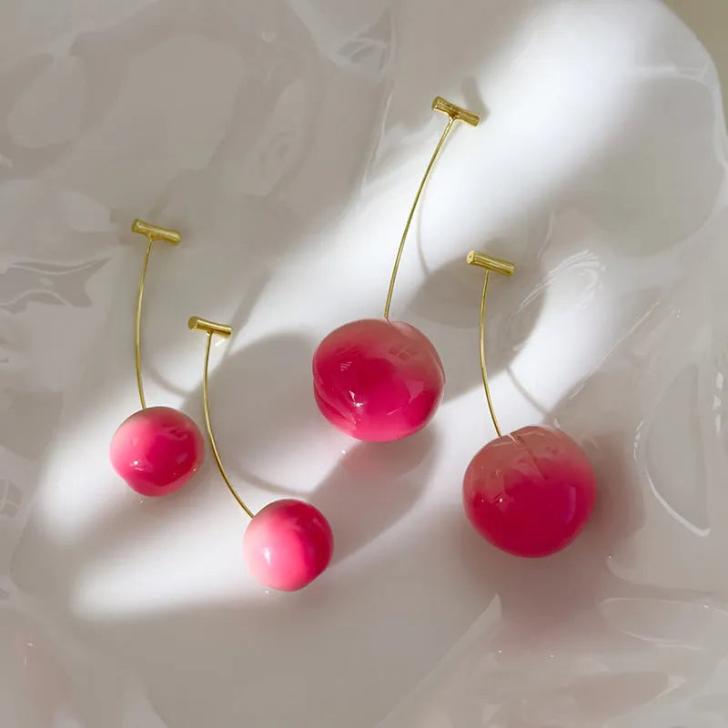 Pair of acrylic peach-shaped earrings on a white background, showing small and large size options.