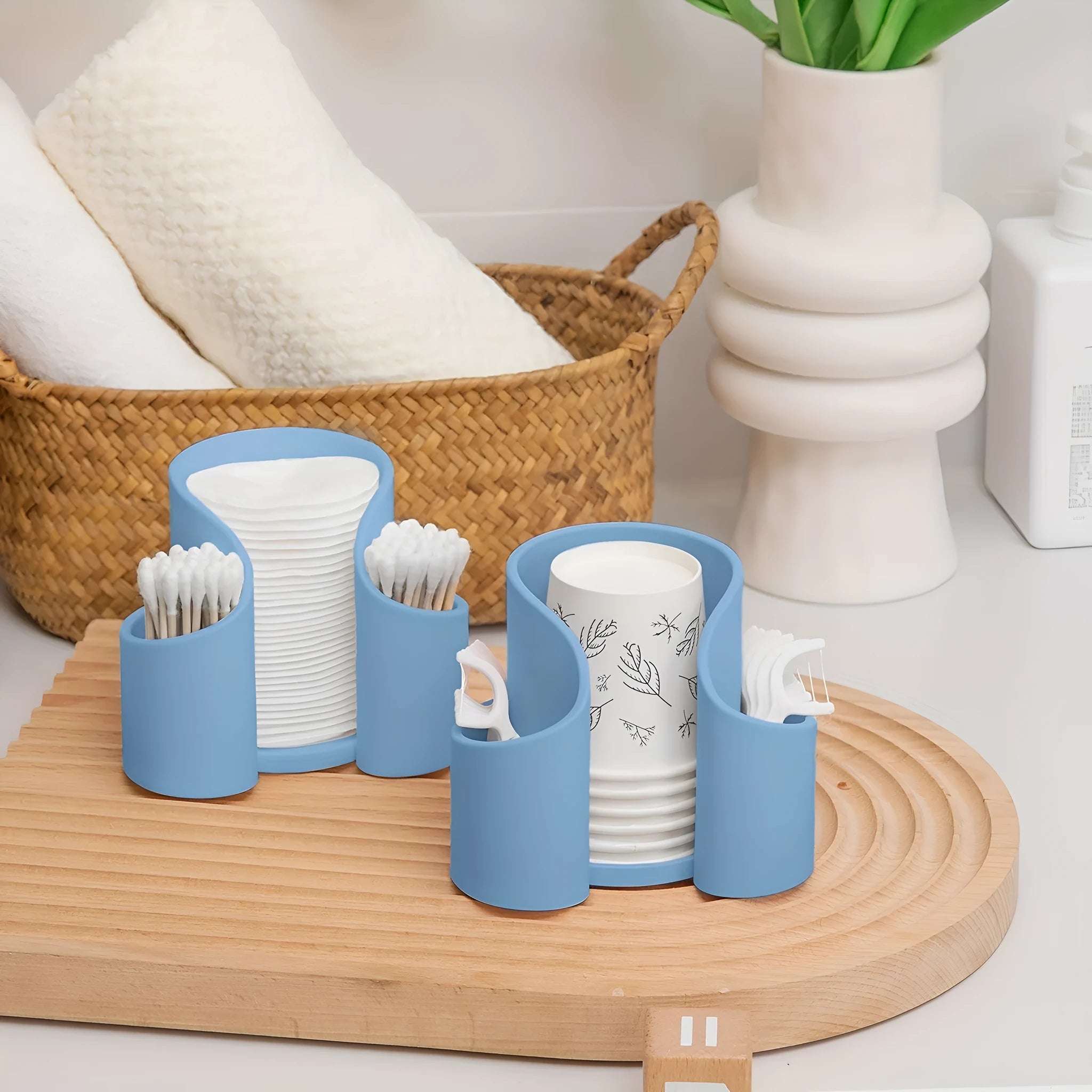 A plastic dental floss storage box in a modern style, shown in solid pink, white, blue, and black colour options.