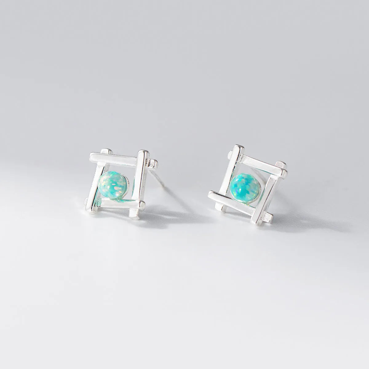 Women's geometric cross quadrangle stud earrings in 925 silver with butterfly clutch closures