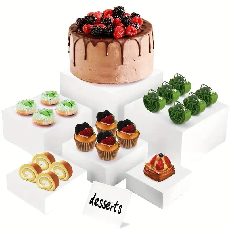 White plastic modular dessert display stand with six interlocking cubes for cake and pastry presentation